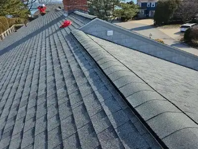Asphalt shingle roof installation in Arlington, Virginia – architectural shingles being installed on residential home by certified roofer