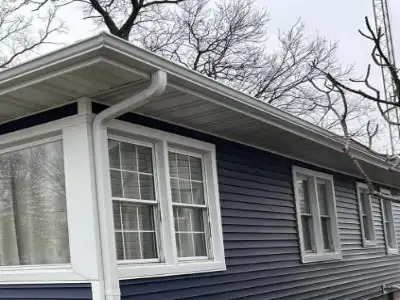 Seamless gutter installation and repair in Arlington, Virginia – aluminum gutters being installed on residential home by local contractor
