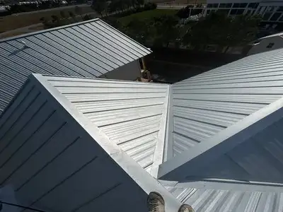 Metal roof installation in Arlington, Virginia – standing seam metal roofing panels being installed on residential home