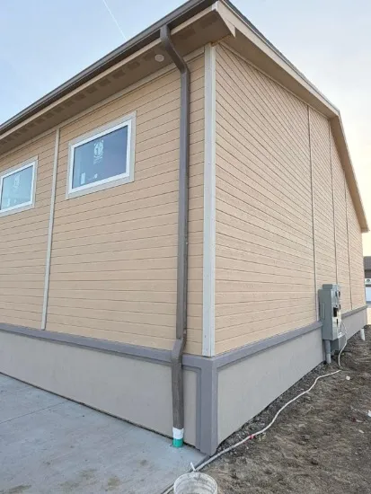 Contractor installing fiber cement siding panels on the exterior of a home in Arlington, VA