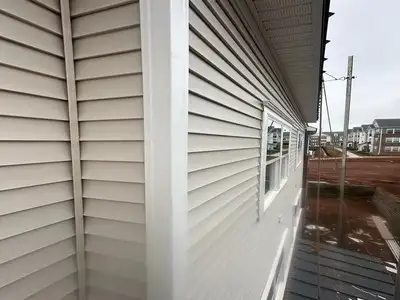 Siding installation and repair in Arlington, Virginia vinyl and fiber cement siding being installed on residential home exterior.