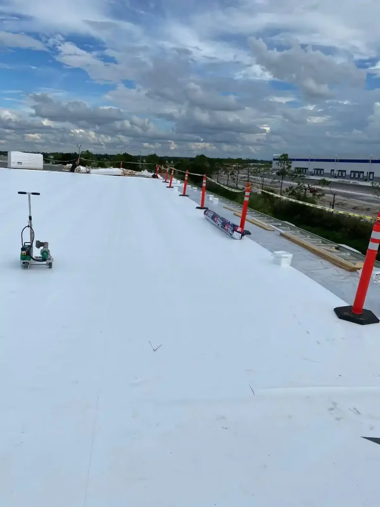 commercial roofer seaming TPO membrane on large flat roof of a multi-unit commercial building in Arlington Virginia .