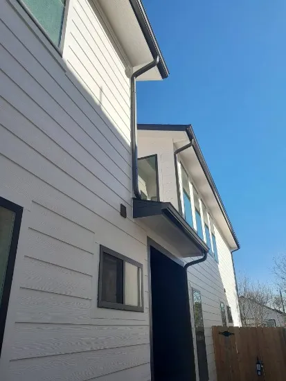 cracked and warped siding panels being replaced on the exterior of an Arlington, VA home